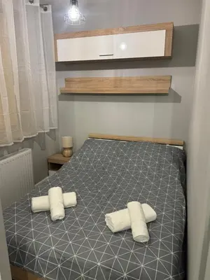 a bedroom with a bed with two towels on it at Mieszkanie z parkingiem podziemnym Przewóz Podgórze in Kraków