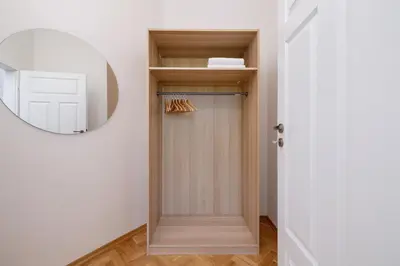 a hallway with a door and a mirror at Jewish Quarter - Augustiańska 1 street in Kraków