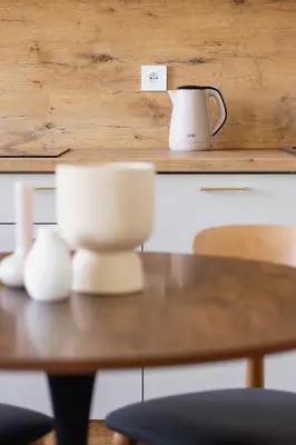 a wooden table with a coffee pot and cups on it at 1 bedroom Apartment - Augustiańska 1 street in Kraków
