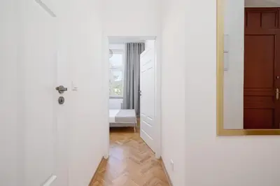 a hallway with a door and a mirror in a room at 1 bedroom Apartment - Augustiańska 1 street in Kraków