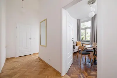 a living room with a table and a mirror at 1 bedroom Apartment - Augustiańska 1 street in Kraków