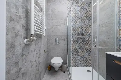 a bathroom with a toilet and a shower at Studio with AC - Augustiańska 1 in Kraków