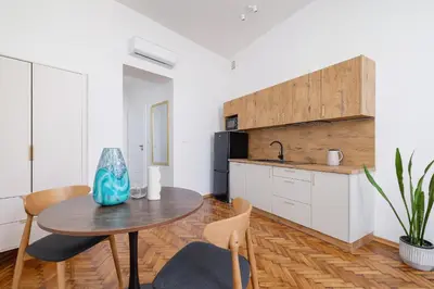 a kitchen and dining room with a table and chairs at Studio with AC - Augustiańska 1 in Kraków