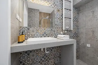 a bathroom with a sink and a mirror at Apartment with the balcony - Augustiańska 1 in Kraków