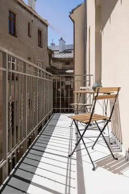 a table and a chair on a balcony at Apartment with the balcony - Augustiańska 1 in Kraków