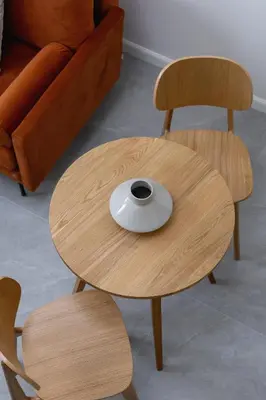 a wooden table with two chairs and a bowl on it at Cosy loft apartment - Jewish Quarter in Kraków