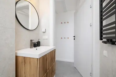a bathroom with a sink and a mirror at Cosy loft apartment - Jewish Quarter in Kraków