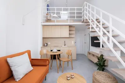 a living room with a couch and a table at Cosy loft apartment - Jewish Quarter in Kraków