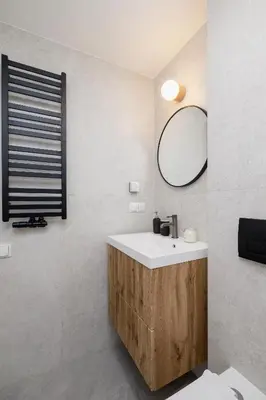 a bathroom with a sink and a mirror at Cozy studio - Augustiańska 1 in Kraków