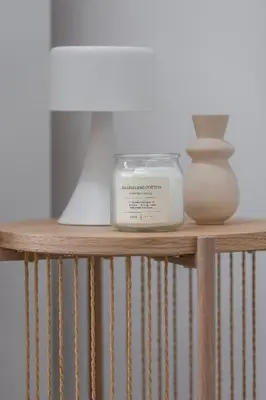 a shelf with a candle and a vase on it at Cozy studio - Augustiańska 1 in Kraków