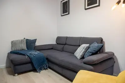 a couch and a chair in a living room at Verona ElevenFive in Kraków