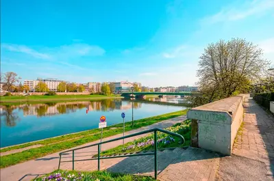 a view of a river with a bridge in the background at Verona ElevenFive in Kraków