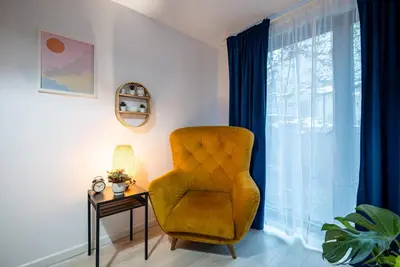 a living room with a chair and a table at Verona ElevenFive in Kraków