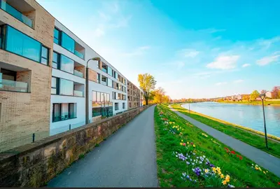 a building next to a body of water at Verona ElevenFive in Kraków