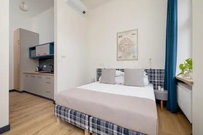 a bedroom with a large bed in a room at Apartment - Augustiańska 1 street in Kraków