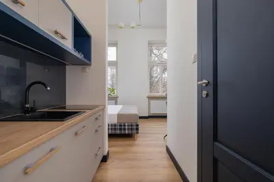 a kitchen with a sink and a bed in a room at Apartment - Augustiańska 1 street in Kraków
