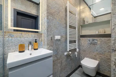 a bathroom with a white sink and a toilet at Apartment - Augustiańska 1 street in Kraków