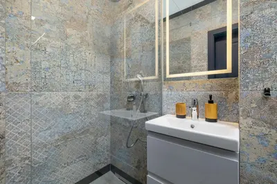 a bathroom with a white sink and a shower at Apartment - Augustiańska 1 street in Kraków
