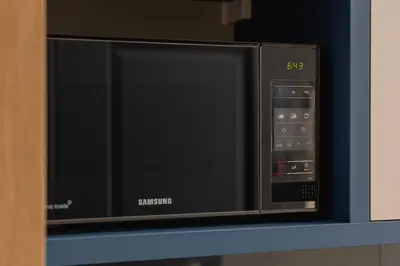 a black microwave oven sitting on a shelf at Apartment - Augustiańska 1 street in Kraków