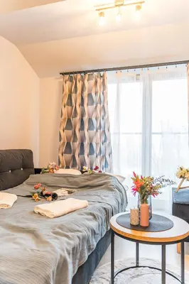 a bedroom with a bed and a table at Kraków Studio - Vistula River nearby - by Rentujemy in Kraków