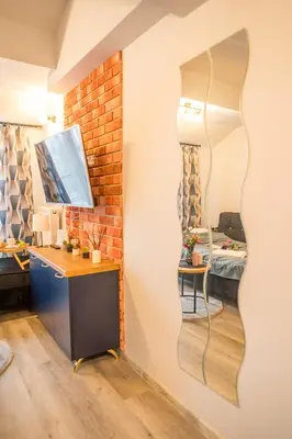 a room with a desk and a mirror on the wall at Kraków Studio - Vistula River nearby - by Rentujemy in Kraków