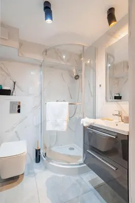 a bathroom with a shower and a toilet and a sink at Kraków Studio - Vistula River nearby - by Rentujemy in Kraków