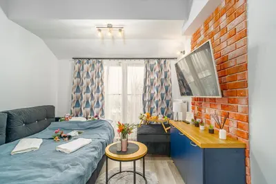a small room with a bed and a couch at Kraków Studio - Vistula River nearby - by Rentujemy in Kraków