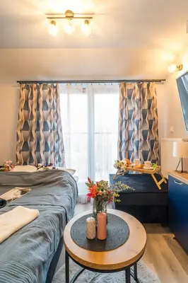 a hotel room with two beds and a table at Kraków Studio - Vistula River nearby - by Rentujemy in Kraków