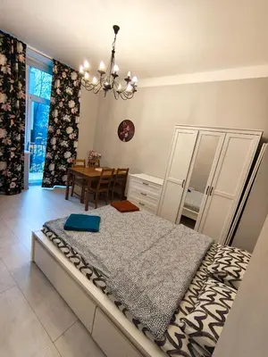 a bedroom with a bed and a dining room at Daniel Apart Hotel Krakow Comfort in Kraków
