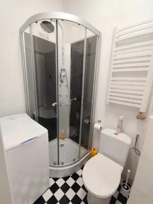 a white bathroom with a sink and a mirror at Daniel Apart Hotel Krakow Comfort in Kraków