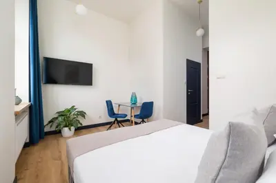 a bedroom with a bed and a table with two chairs at Jewish Quarter- Augustiańska 1- AC in Kraków