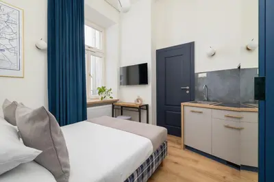 a hotel room with a bed and a kitchen at Apartment- AC - Augustiańska 1- Jewish Quarter in Kraków