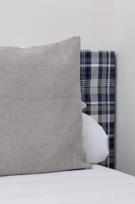 a pillow sitting on top of a bed at Apartment- AC - Augustiańska 1- Jewish Quarter in Kraków