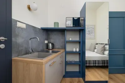 a small kitchen with a sink and a bunk bed at Apartment - Augustiańska 1 - Studio for 2 in Kraków
