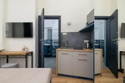 a kitchen with a sink and a desk in a room at Apartment - Augustiańska 1 - Studio for 2 in Kraków