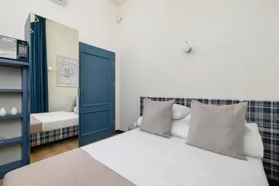 a bedroom with a bed and a blue door at Apartment - Augustiańska 1 - Studio for 2 in Kraków