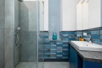 a bathroom with a sink and a glass shower at Apartment - Augustiańska 1 - Studio for 2 in Kraków