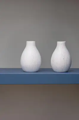 three white vases sitting on a blue shelf at Apartment - Augustiańska 1 - Studio for 2 in Kraków