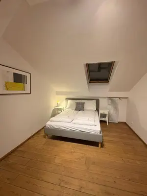 a bedroom with a bed and a wooden floor at Apartment next to Wawel Castle and the Vistula River, air conditioning in Kraków