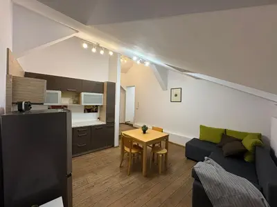 a living room with a couch and a table at Apartment next to Wawel Castle and the Vistula River, air conditioning in Kraków