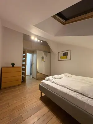 a bedroom with a bed and a ladder in it at Apartment next to Wawel Castle and the Vistula River, air conditioning in Kraków