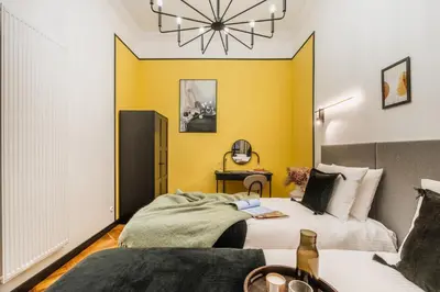a bedroom with a bed with an orange wall at Pinata Apartment - Orzeszkowej 8 in Kraków