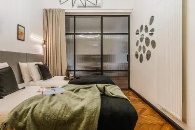 a living room with a table and a vase with flowers at Pinata Apartment - Orzeszkowej 8 in Kraków