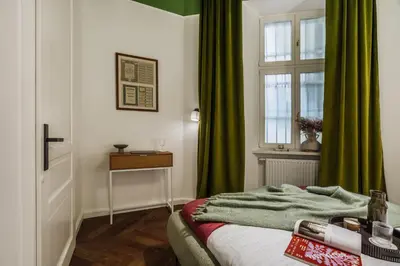 a hotel room with two beds with books on them at Pinata Apartment - Orzeszkowej 8 in Kraków