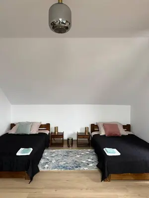 a room with two beds sitting next to each other at Wynajmowanie pokoi in Szczyglice