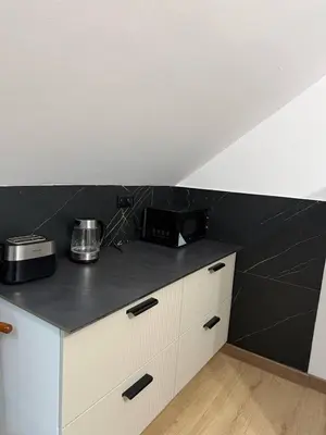 a kitchen with a black and white counter top at Wynajmowanie pokoi in Szczyglice