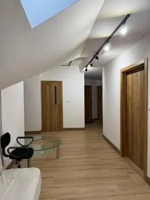 a living room with a glass table and a couch at Wynajmowanie pokoi in Szczyglice