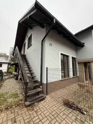 a house with a staircase in front of it at Wynajmowanie pokoi in Szczyglice