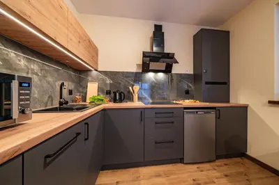 a kitchen with gray cabinets and a counter top at Burnosówka in Nowy Targ