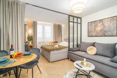 a living room with a couch and a table at Beautiful apartment in the city center, air conditioning, elevator in Kraków
